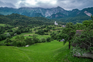 Fototapeta na wymiar Drežnica village, Slovenia. Drone aerial view. Picturesque rural green landscape