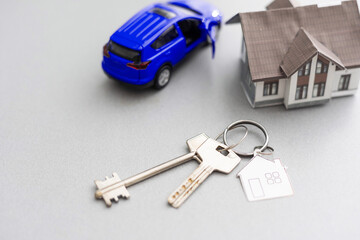 car and house model for sale with money, key on background, house for sale concept, closeup.