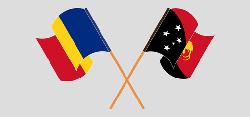Crossed and waving flags of Romania and Papua New Guinea