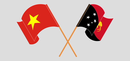 Crossed and waving flags of Vietnam and Papua New Guinea