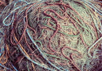 Sea nets background, fishing equipment and tackle as a decoration for your marine style concept. Heap of fishing nets - traditional element of craft the fishermen. - 619827389