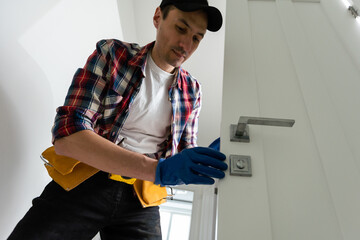 Man removing lock from door 