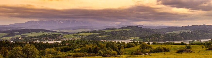 Beautiful panorama of Czorsztyn Lake at sunset. Castle in Czorsztyn, Castle in Niedzica. Tatry mountains in the background. Pieniny range.