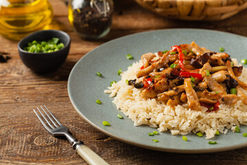 Pork chop with peppers, mushrooms and bamboo. Served with rice.