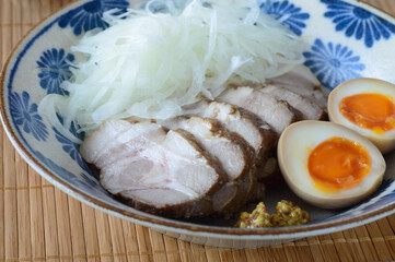 a plate of Japanese chashu with seasoned soft boiled egg served with fresh onion, food, meat, meal, plate, pork, dish, vegetable, lunch, egg
