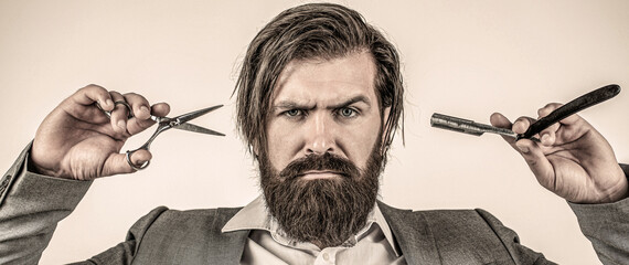 Portrait bearded man. Brutal guy, scissors, straight razor. Bearded client visiting barber shop. Barber scissors and straight razor, barber shop, suit