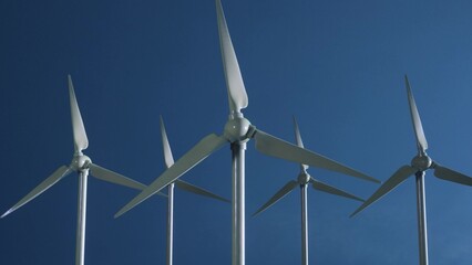 Wind turbines with blue sky. Green energy. Renewable and sustainable resources. Electricity generation. 3d illustration