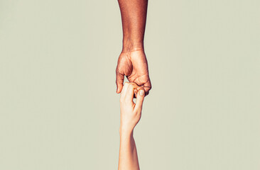 Helping hands, Rescue gesture. Black and white human hands. Giving a helping hand to another. Woman...