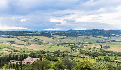 Fototapeta premium Scenic and picturesque view of Tuscany countryside rolling hills and farmland from above ancient city of Montepulciano