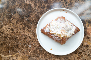 almonds cream croissant on plate