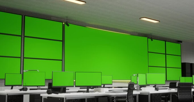 Big Green Screen Horizontal Mock Up In A Control Security Center Room With Many Green Screen Mock Up Computers On Tables At The Office
