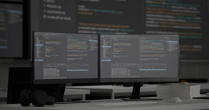Close Up Of Terminal Window Desktops Showing Code On Black Screen Background On The Table In Front Of Multiple Monitors With Database In A Control Security Center
