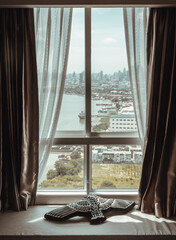Black bird pillow puts on cushion seat beside the window. Looking through the bedrooms window can see the beautiful Bangkok City View and Chao Phraya River. Space for text.