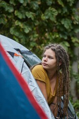 Woman getting out the tent