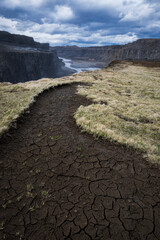 Dry ground full of cracks next to the canyon with the river jökula a fjöllum in iceland in summer