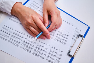 Admission test. Examination form. Choosing the correct answer. A sheet of paper with a test task. School exam. University quiz. Right or wrong option. Student to study. Elementary school question