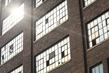 Fototapeta na wymiar Exterior windows on an abandoned industrial building