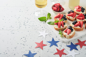 American flag sandwich with strawberries, blueberries, whipped sweet cream, soft cheese on toast bread. 4th of July American Independence Day food. Independence or Patriotic Day breakfast idea Mock up