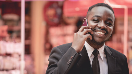 Happy african business man phone call and talking on walk for contact, chat or good deal and smile on street.Black man using smartphone and talk for networking, sales or stock trading on road.