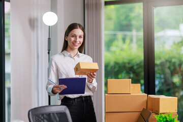 Concept of parcel delivery and selling online,Retailer writing customer detail on parcel box and prepare to send product parcel to the customer