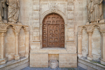 Fototapeta na wymiar Small wooden door on the facade of the Cathedral of Burgos