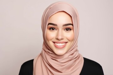 Portrait of beautiful young muslim woman with hijab smiling on grey background - obrazy, fototapety, plakaty