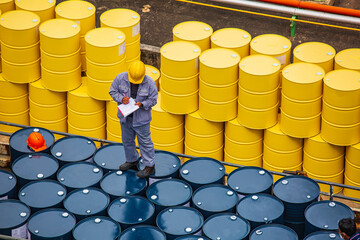 Male worker inspection record drum oil stock barrels yellow vertical or chemical for transportation...