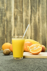 Fresh orange juice in a glass with a straw