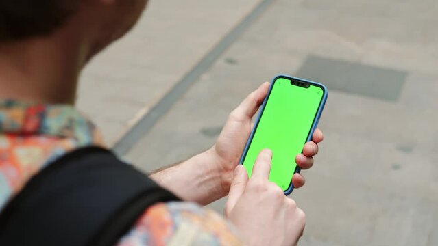 Green Screen chroma key on Smartphone phone in Barcelona city view, Spain, Travel with phone concept, application mock up. City street in europe.