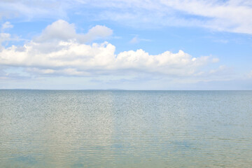Beautiful white clouds float over a calm sea