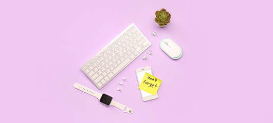 Sticky note with text DON'T FORGET and modern gadgets on lilac background