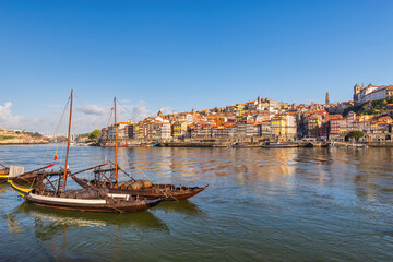 Fototapeta na wymiar Porto Portugal, city skyline at Porto Ribeira and Douro River with Rabelo wine boat