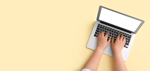 Fototapeta na wymiar Hands with modern laptop on color background. Banner or design