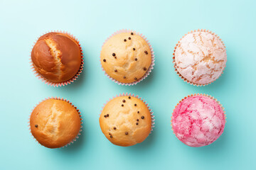 Top view of the delicious biscuit muffins. Assortment of simple cupcakes without cream isolated on a pastel light flat blue background with copy space. Generative AI.