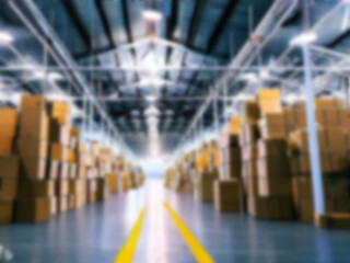 Blurred  A warehouse where the goods are packed in a large number of brown cardboard boxes.