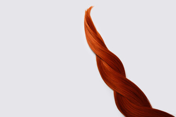 Braided ginger hair on white background, closeup