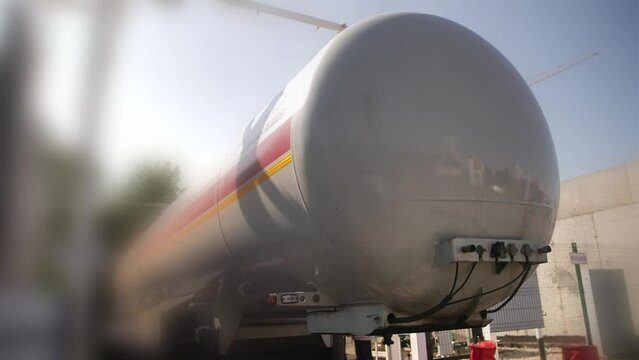 Rear view of trailer tanker truck or fuel tank transporting oil or gasoline to final destination. 
Transportation of the crude oil and diesel fuel to the refinery storage via railroad by freight train