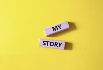 My story symbol. Wooden blocks with words My story Beautiful yellow background. Business and My story concept. Copy space.