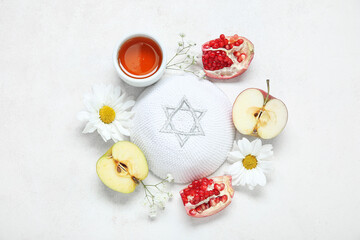 Fototapeta na wymiar Composition with kippah, ripe fruits, flowers and honey on light background. Rosh hashanah (Jewish New Year) celebration