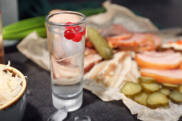 Shot with cold vodka on black background