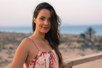 portrait of smiling brunette woman on the beach