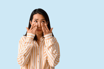 Allergic Asian woman on blue background