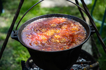 boiling chili con carne in a cauldron