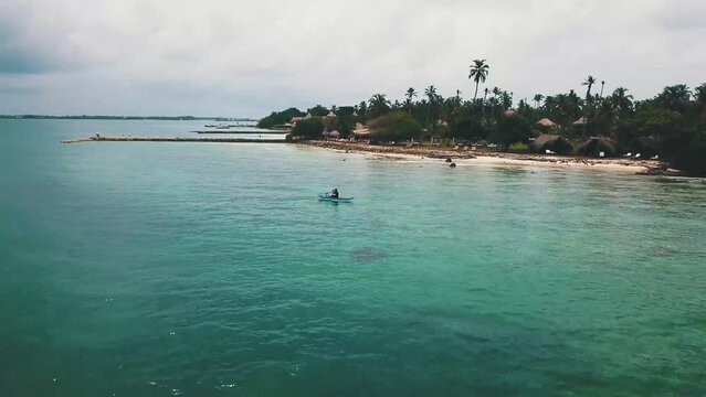 Man in canoe on the caribbean sea, in the san bernardo archipelago