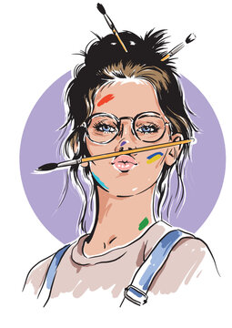 Girl with a paint brush in her mouth and painted face