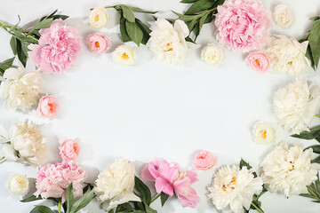 Beautiful peony flowers and roses on a light background, flower arrangement with place for text, summer banner, greeting card for wedding, birthday, template for design, selective focus