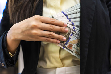 Investor woman with stack of banknotes in hand, Business Concept