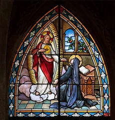 Tuinposter BIELLA, ITALY - JULY 15, 2022: The apparition of apparition of Heart Jesus to St. Theresa of Avila in the stained glass of Duomo from 19. cent. © Renáta Sedmáková