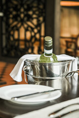 Bottle of white wine in an ice bucket served in a restaurant