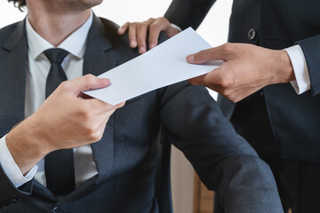 Close up view of boss giving commission bonus to office worker.